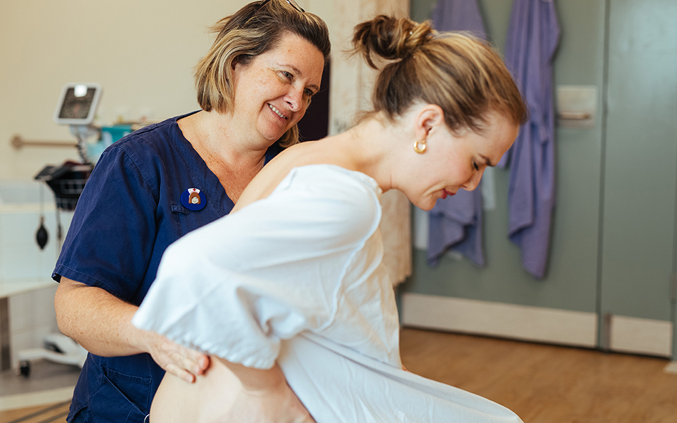 Midwife supporting a pregnant woman in labour