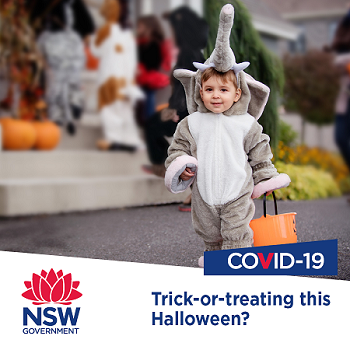 Small child walking down street tirck-or-treating in elephant costume