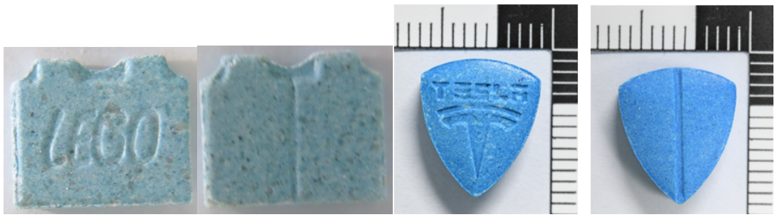 A light blue tablet shaped like a lego brick with Lego stamped on it, and a bright blue tablet with the Tesla logo stamped on it.