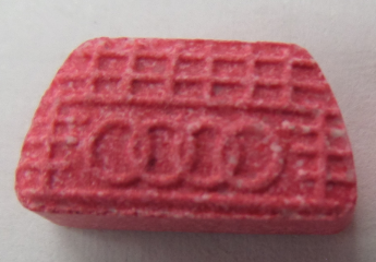 Pink MDMA tablet with hatch and four circles