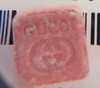 High dose MDMA ecstasy tablets pink orange square tablets with a GUCCI logo and wording