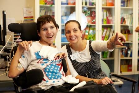Young cerebral palsy boy with carer