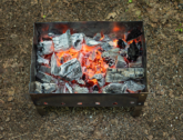 A charcoal barbeque on the ground