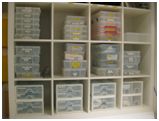 Skin penetration equipment and utensils are stored in sealed plastic bags on a designated shelf.