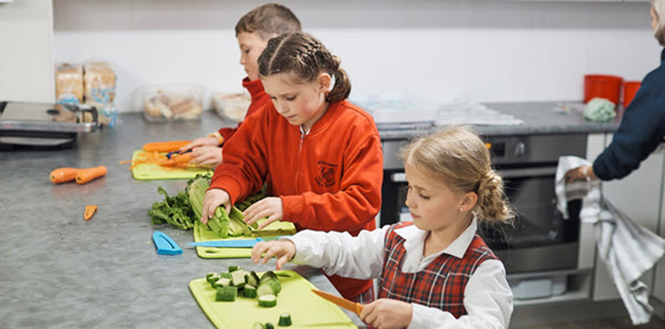Children cutting vegetables