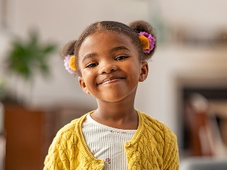 A 4 year old child smiling.