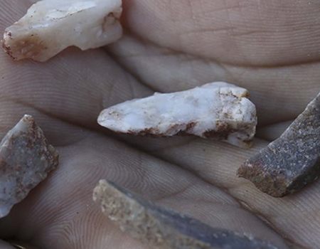 Aboriginal artifacts, small pieces of stone held in a hand