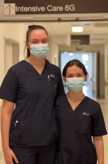 Two female nurses in hospital setting.