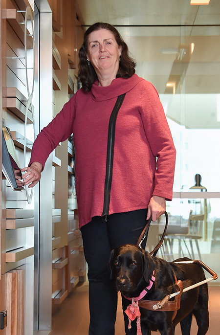 Margaret Booth standing with her guide dog.