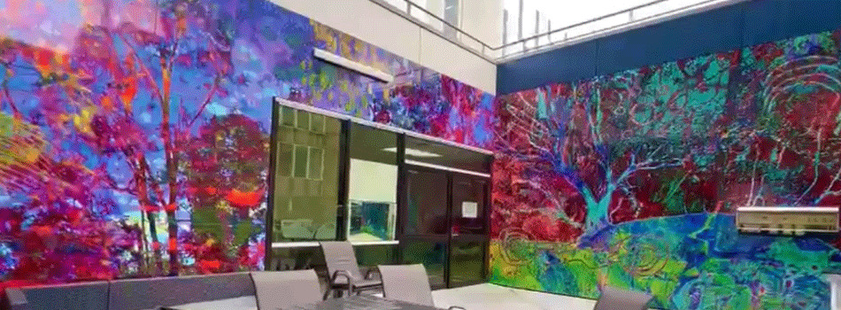 Murals on walls of an outdoor balcony, featuring trees in bright colours