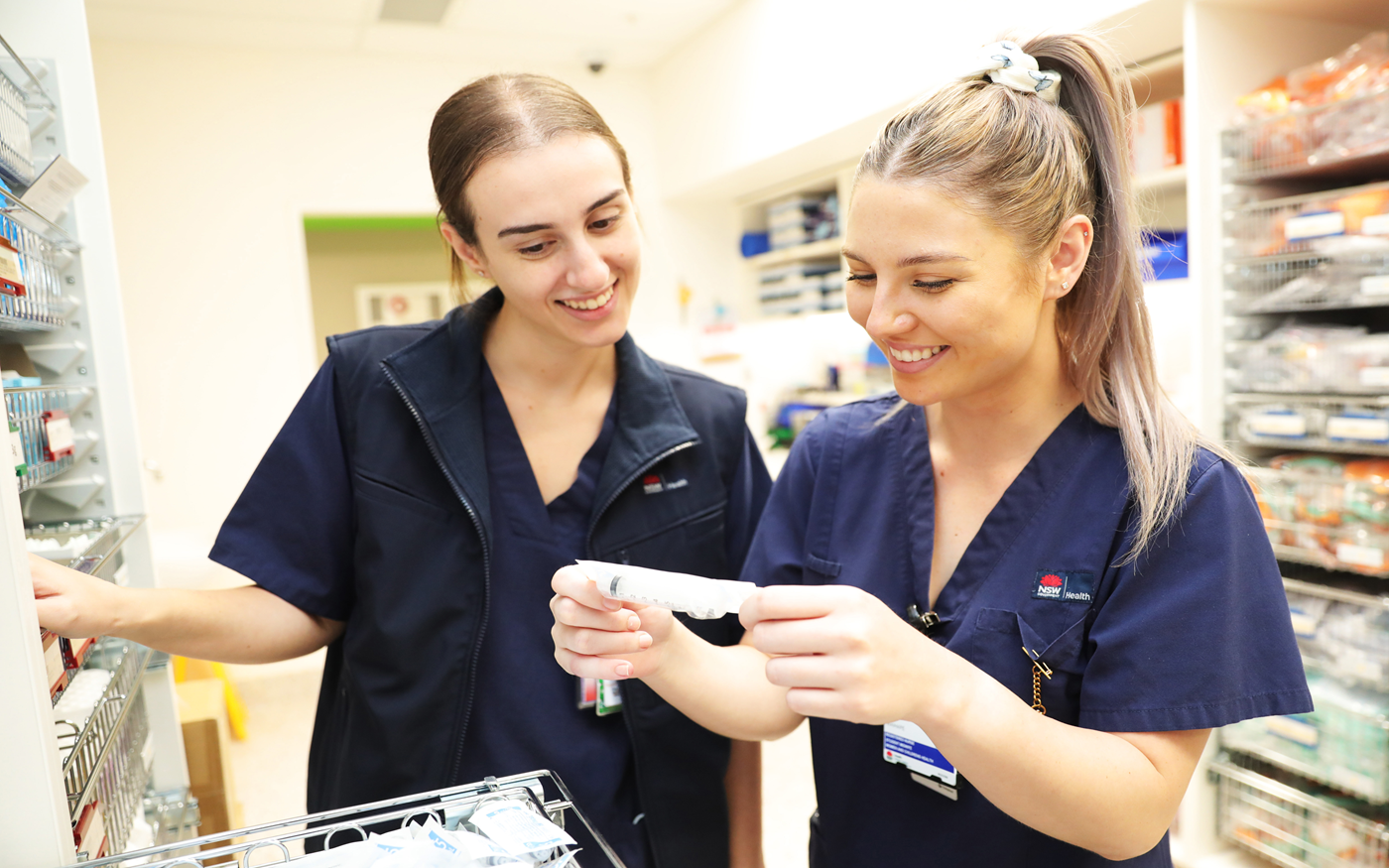 Two registered nurses reviewing notes
