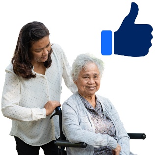 A person pushing another person in a wheelchair with a thumbs-up icon above them.