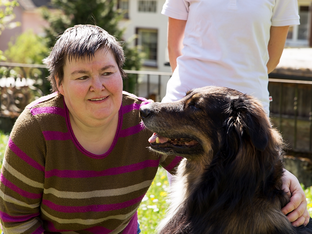 A person holding a dog.