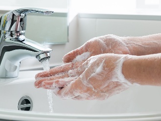 A person washing their hands.