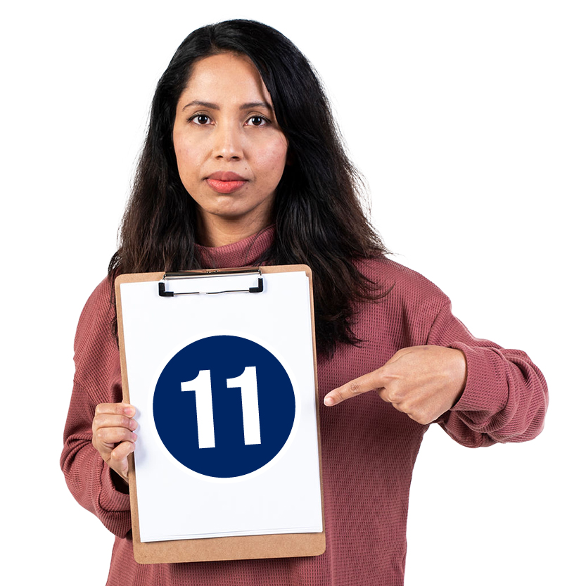 A person pointing to a clipboard they're holding. The number '11' is on the clipboard.