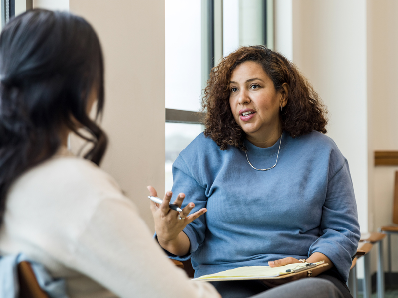 A psychologist meeting with a person.