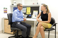 An allied health professional helping a patient.