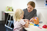 A speech pathologist working with a child