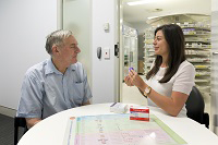 A pharmacist talking to a patient