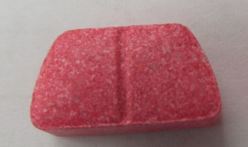 Pink MDMA tablet with line etched in middle